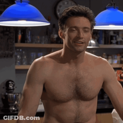 A Shirtless Man Is Standing In Front Of A Clock GIF