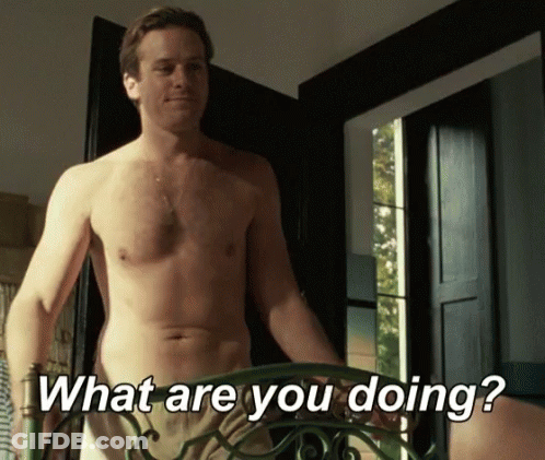 A Shirtless Man Is Standing In Front Of A Door And Asking " What Are You Doing " GIF