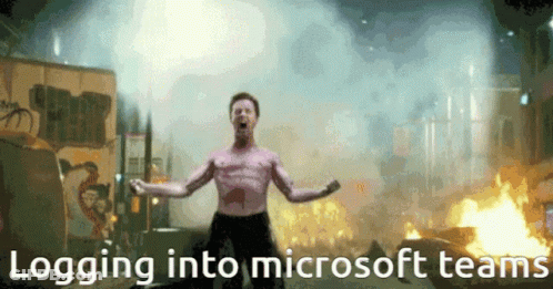 A Shirtless Man Is Standing In Front Of A Fire With The Words Logging Into Microsoft Teams GIF
