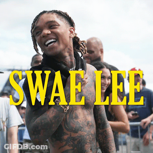 A Shirtless Man Is Standing In Front Of A Sign That Says Swaelee GIF