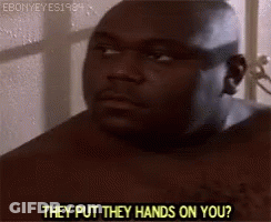 A Shirtless Man Is Standing In Front Of A Window Talking To Someone . GIF