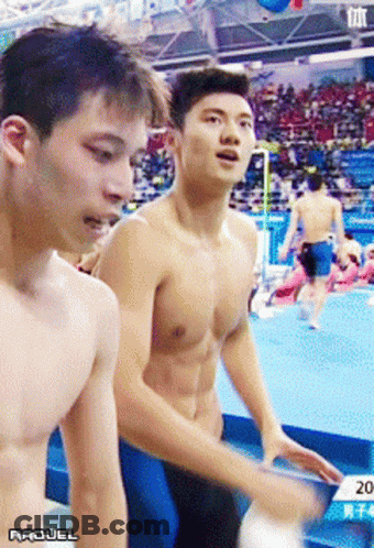 A Shirtless Man Is Standing Next To Another Shirtless Man With The Year 2014 On The Bottom Right GIF