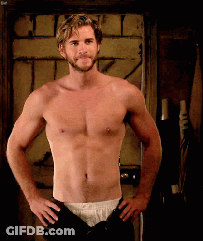 A Shirtless Man Is Standing With His Hands On His Hips In Front Of A Door With The Letters Bw On It GIF