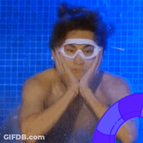 A Shirtless Man Is Swimming In A Pool Wearing Goggles . GIF