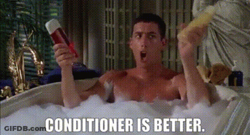 A Shirtless Man Is Taking A Bath In A Bathtub While Holding A Conditioner And A Sponge . GIF