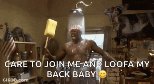 A Shirtless Man Is Taking A Shower And Holding A Yellow Sponge .. GIF