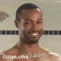 A Shirtless Man Is Taking A Shower And Smiling . GIF