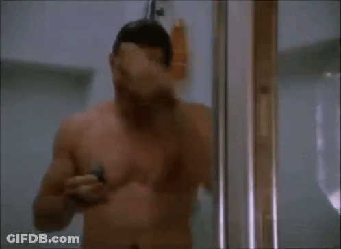 A Shirtless Man Is Taking A Shower And Using A Razor GIF
