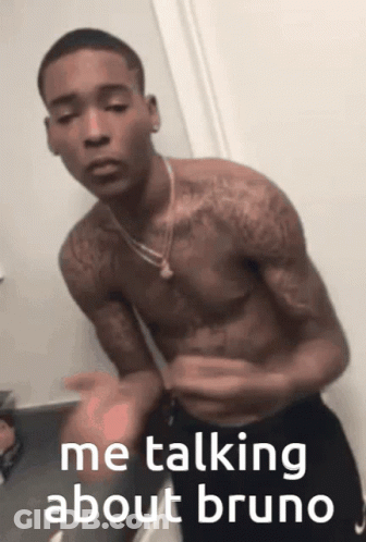 A Shirtless Man Is Talking About Bruno While Standing In Front Of A Mirror GIF