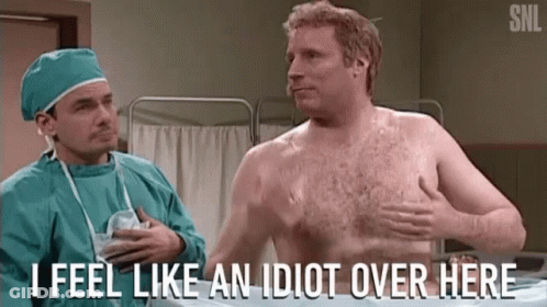 A Shirtless Man Is Talking To A Surgeon In An Operating Room And Says " I Feel Like An Idiot Over Here " . GIF