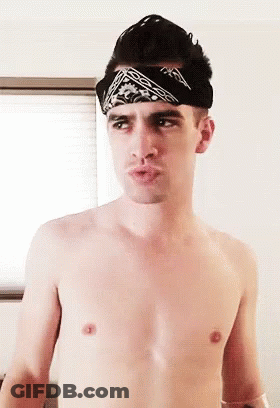 A Shirtless Man Is Wearing A Bandana On His Head . GIF
