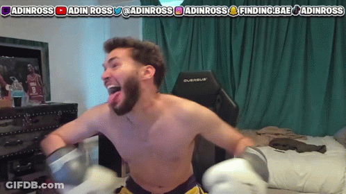 A Shirtless Man Is Wearing Boxing Gloves In Front Of A Screen That Says Adinross GIF