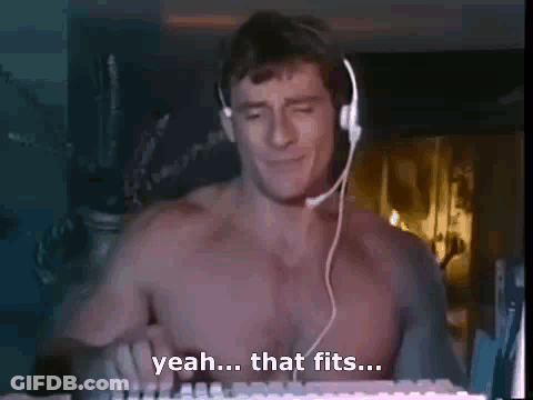 A Shirtless Man Is Wearing Headphones And Playing A Keyboard . GIF