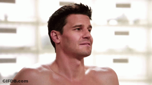 A Shirtless Man Looks At The Camera With A Serious Look On His Face GIF