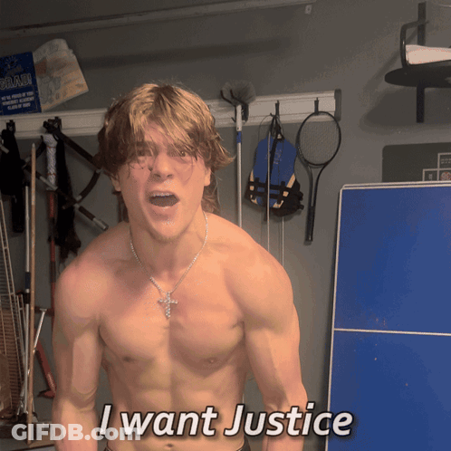 A Shirtless Man Says I Want Justice In Front Of A Blue Table GIF