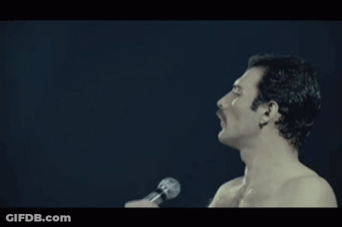 A Shirtless Man Singing Into A Microphone With The Word Pressure Written Below Him GIF