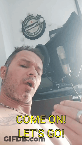A Shirtless Man Singing Into A Microphone With The Words Come On Let 'S Go Below Him GIF