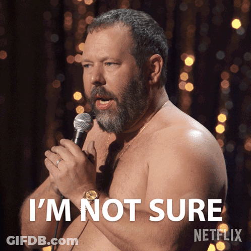 A Shirtless Man Speaking Into A Microphone With The Words I 'M Not Sure On The Bottom GIF