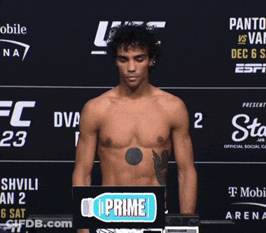 A Shirtless Man Standing In Front Of A Sign That Says Prime GIF