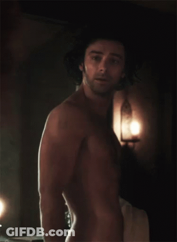 A Shirtless Man Stands In A Dark Room GIF