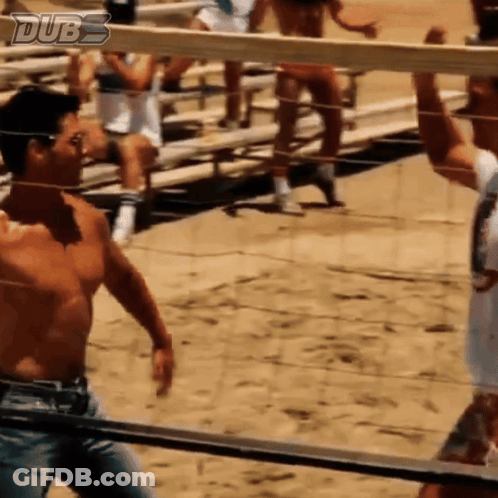 A Shirtless Man Stands In Front Of A Volleyball Net With Dubs Written On The Bottom GIF