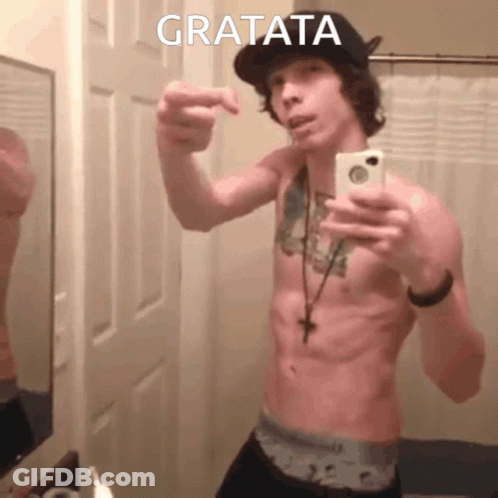 A Shirtless Man Taking A Selfie With Gratata Written On The Bottom Right GIF