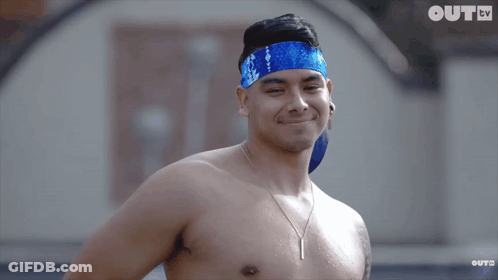 A Shirtless Man Wearing A Blue Headband Is Smiling In Front Of A Screen That Says Oute Tv GIF