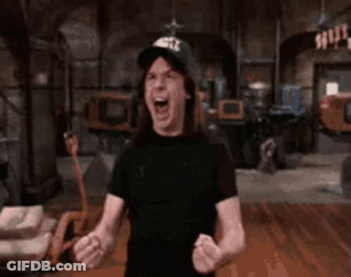 A Shirtless Man Wearing A Hat Is Screaming In A Dark Room . GIF