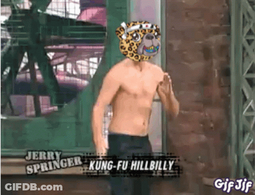 A Shirtless Man Wearing A Leopard Mask Is Standing In Front Of A Building . GIF