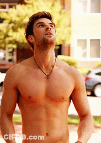 A Shirtless Man Wearing A Necklace Looks Up At Something GIF