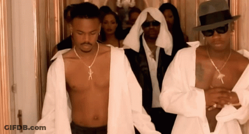 A Shirtless Man Wearing A Necklace That Says X On It GIF