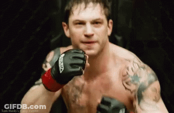 A Shirtless Man Wearing A Pair Of Boxing Gloves With The Word Venum On Them GIF