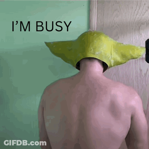A Shirtless Man Wearing A Yellow Hat With The Words I 'M Busy Behind Him GIF