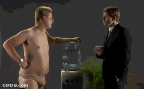 A Shirtless Man Wearing Glasses Is Making A Funny Face GIF