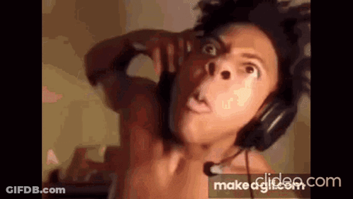 A Shirtless Man Wearing Headphones And A Microphone . GIF