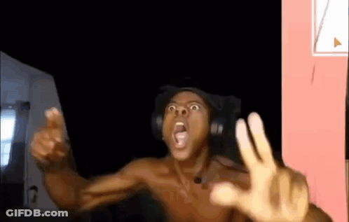 A Shirtless Man Wearing Headphones Is Making A Funny Face While Sitting In A Chair . GIF