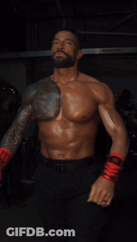 A Shirtless Man Wearing Red Boxing Gloves And Black Pants GIF