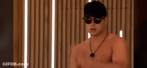 A Shirtless Man Wearing Sunglasses And A Baseball Cap . GIF