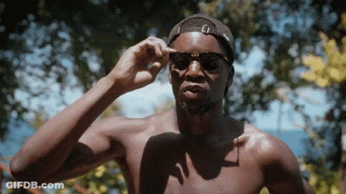 A Shirtless Man Wearing Sunglasses And A Black Hat GIF