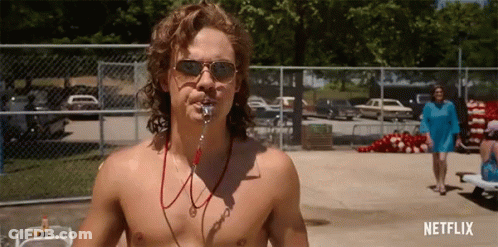 A Shirtless Man Wearing Sunglasses And A Life Preserver Stands In Front Of A Fence With Netflix Written On The Bottom GIF