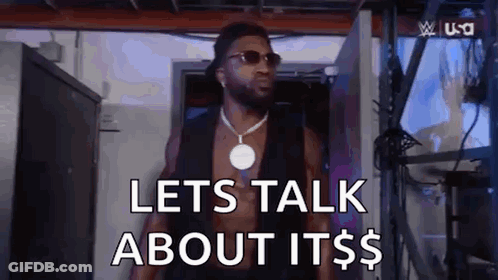 A Shirtless Man Wearing Sunglasses And A Necklace Is Standing In A Room And Saying `` Lets Talk About It $ '' . GIF