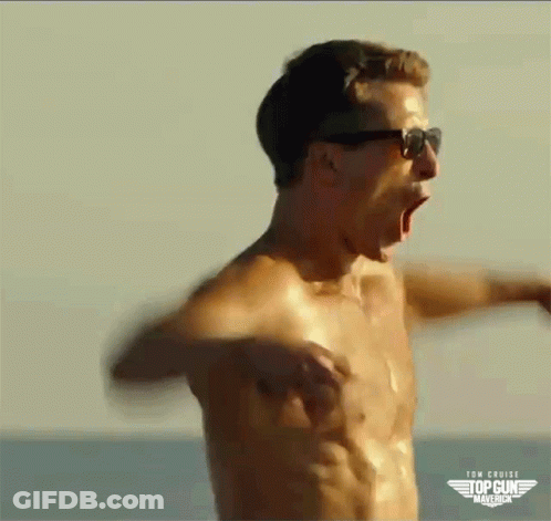 A Shirtless Man Wearing Sunglasses Is Screaming On The Beach . GIF