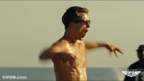 A Shirtless Man Wearing Sunglasses Stands In Front Of A Sign That Says Tom Cruise Top Gun America GIF