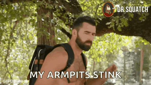 A Shirtless Man With A Backpack Says " My Armpits Stink " While Standing Under A Tree . GIF