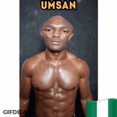 A Shirtless Man With A Bald Head Is Standing Next To A Green And White Flag . GIF