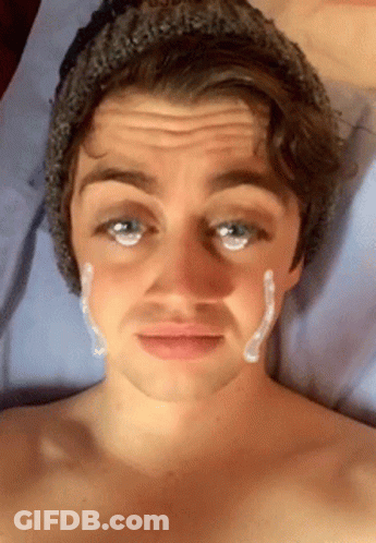 A Shirtless Man With A Beanie On Has A Tear Coming Out Of His Eye GIF