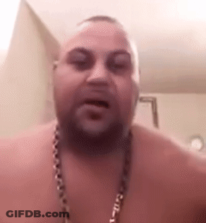 A Shirtless Man With A Beard And A Chain Around His Neck Is Talking To The Camera . GIF