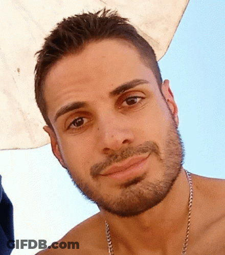 A Shirtless Man With A Beard And Chain Around His Neck GIF