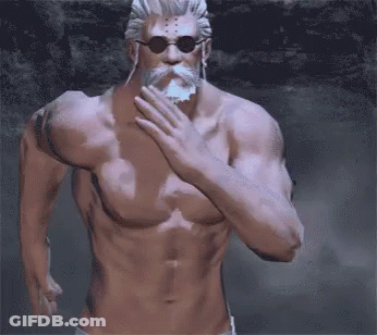 A Shirtless Man With A Beard And Sunglasses Covers His Mouth GIF
