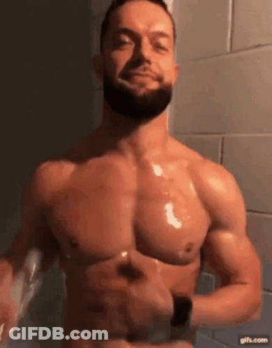 A Shirtless Man With A Beard Is Brushing His Teeth With A Toothbrush In A Bathroom . GIF